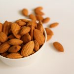 brown almond nuts on white ceramic bowl