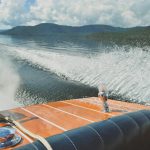 brown speedboat on top of body of water